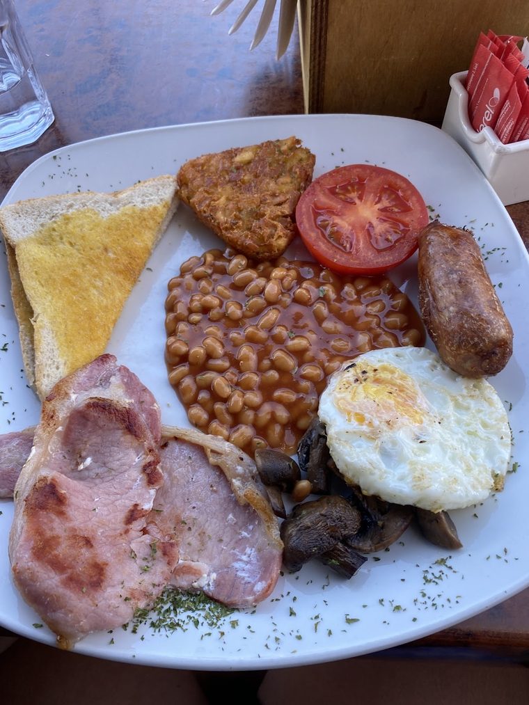 Full English breakfast on a white plate